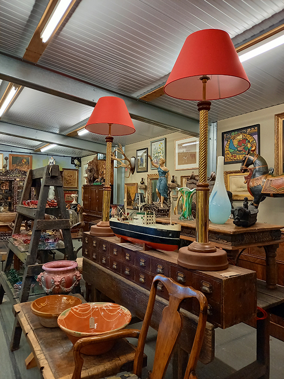 a view of the shop focussing on 2 tall red side lamps
