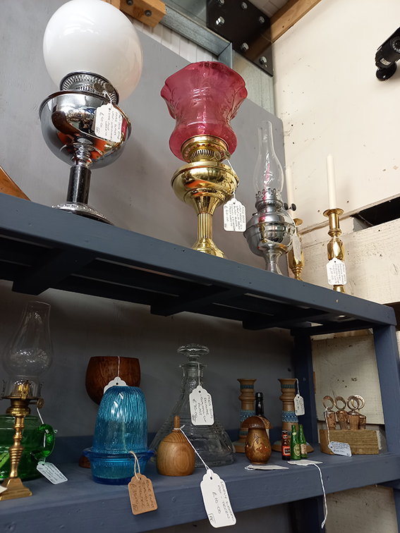 A selection of old parafin lamps on a shelf