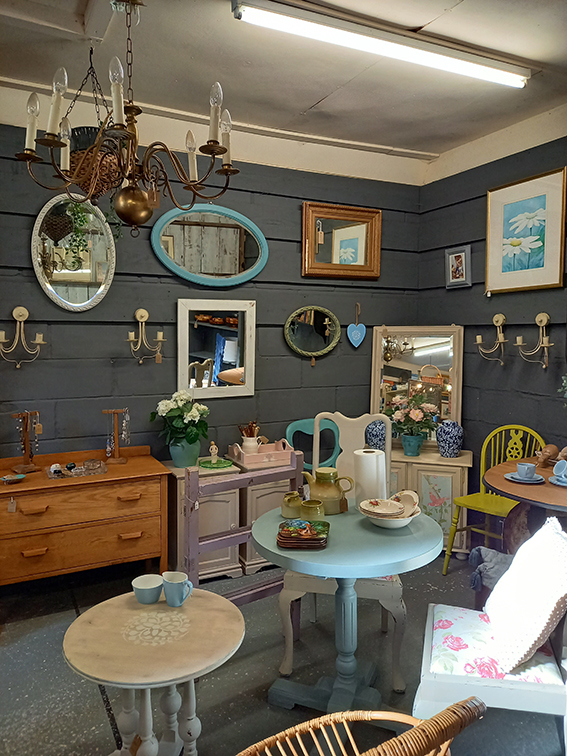 Inside Holt Antiques - a wall filled with antique mirrors and curiosities